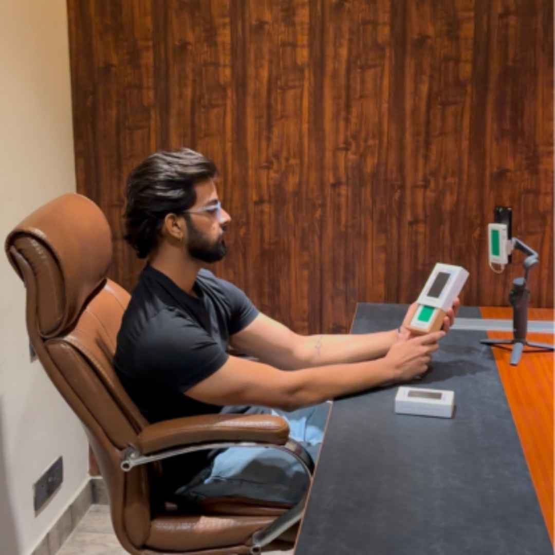 A man holding a MagMirror product in hand during a professional product photography session.