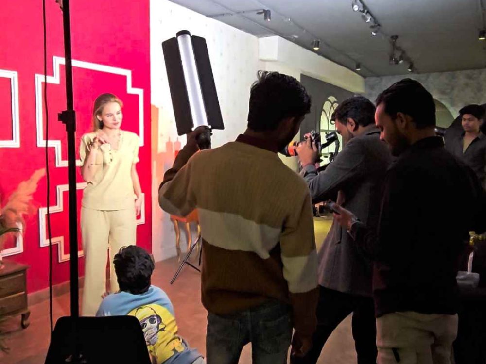 Model showcasing a clothing brand outfit during a product photography shoot